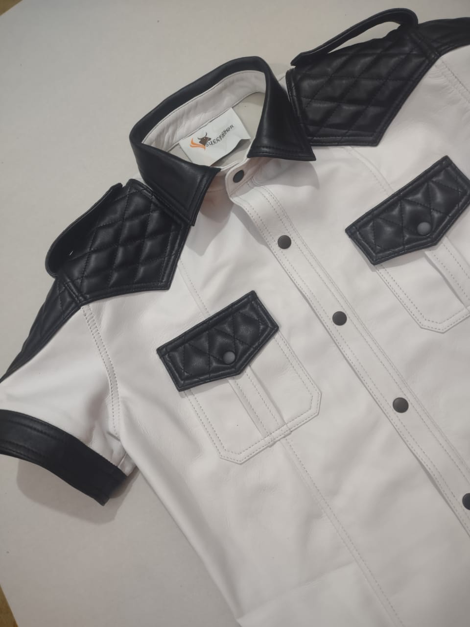 WHITE LEATHER SHIRT WITH BLACK QUILTED CONTRAST.