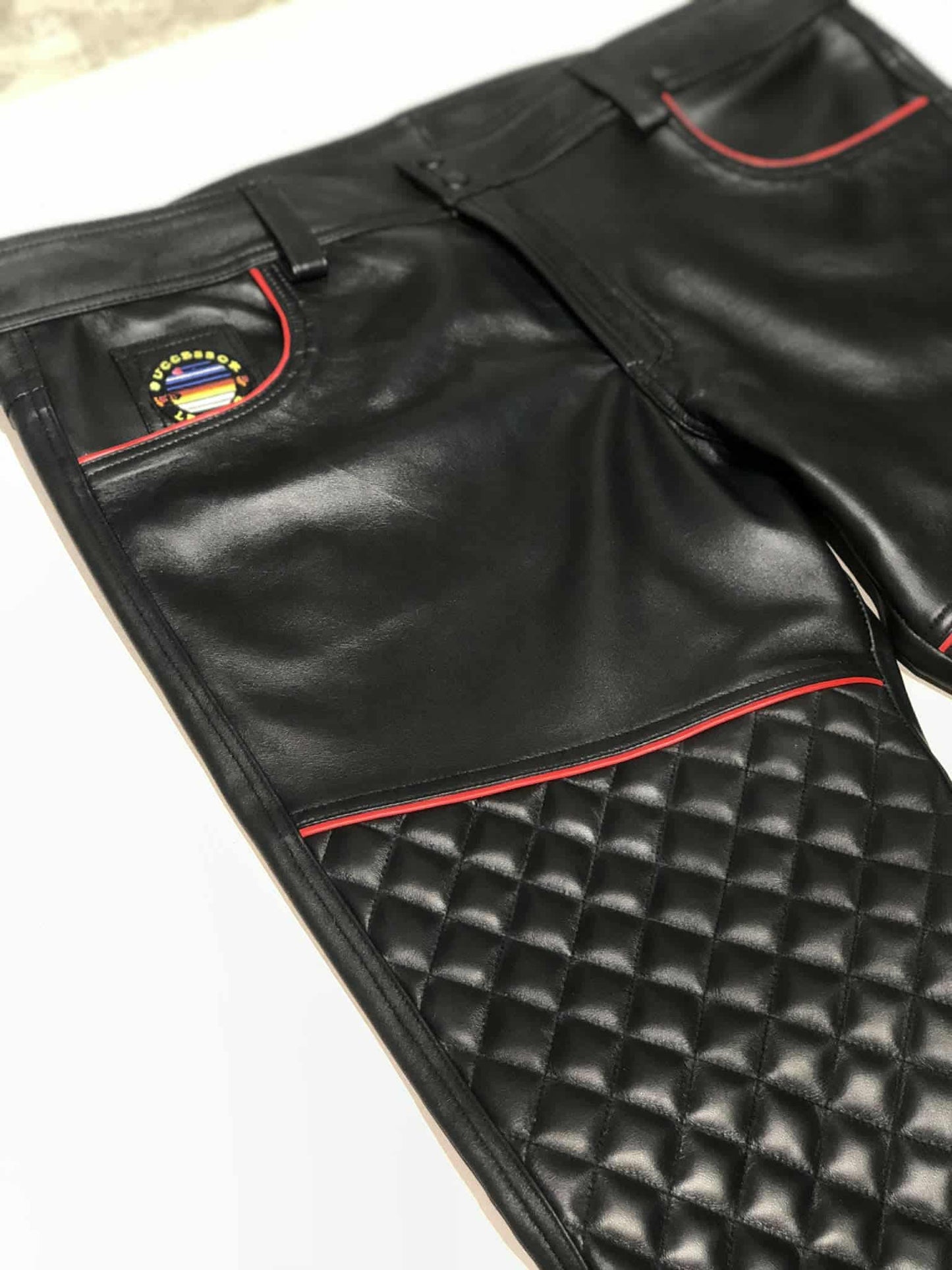 BLACK LAMB LEATHER QULITED PANT WITH RED TRIMS.