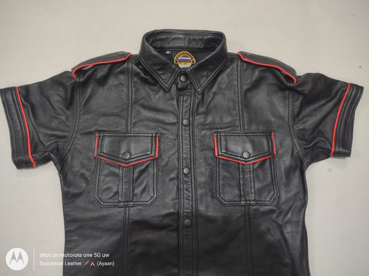 BLACK LEATHER SHIRT WITH RED CONTRAST.