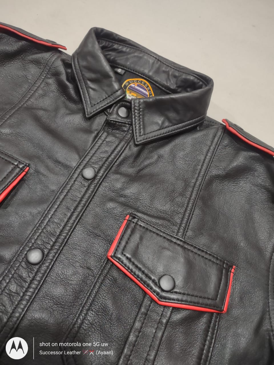 BLACK LEATHER SHIRT WITH RED CONTRAST.