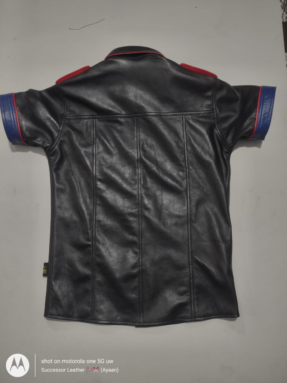 BLACK LEATHER SHIRT WITH RED CONTRAST.